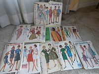 Photo of 1960s sewing patterns by Simplicity featuring dresses, skirts, pants and blouses with colorful illustrations