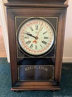 Elgin Regulator wall clock front view showing entire clock and 'REGULATOR' text on bottom glass panel