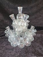 Full view of glass floral seven arranger showing seven connected vases forming a circular cluster with a taller central vase.