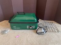 Full view of the NESCO Roast-Air Oven 18 in green enamel with lid, metal roasting rack, power cord, and instructions/parts.