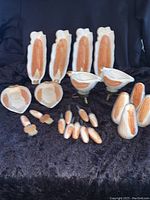 Full lot including corn-shaped dishes, butter warmers, salt and pepper shakers, corn holders, butter brushes, and condiment dishes.