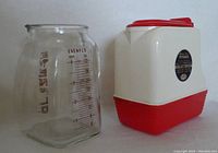 Photo showing the Evenflo glass measuring pitcher and lustre-ware pitcher side by side, highlighting size and label details.