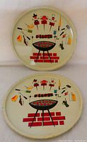 Front view of 2 mid-century metal BBQ serving trays showing colorful lithographed BBQ grill and tools design