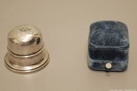 Photo of both ring boxes, showing the silver Birks box with dent and blue velvet box side by side