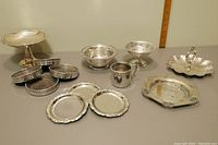 Overview photo showing full set of coasters, mugs, candy bowls, and trays arranged together