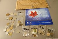 Coins from Asia, Fiji, Dominica, Peru, Spain in labeled bags and loose coins, 1999 Millennium collection and 2010 Vancouver Olympic circulation coin sets in packaging.