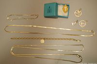 Overhead view of bracelets, necklaces, brooch and charms