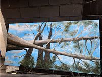 Full view of the mixed media acrylic painting showing the tree and blue sky background.