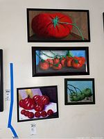 Four tomato-themed paintings displayed on wall showing full lot contents and framing style