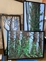 Three framed mixed media artworks by Donald Gotz shown together, highlighting detailed tree trunks and ivy leaves with textured green elements.