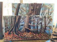 Front view of two mixed media art panels depicting tree trunks and branches with natural materials and painted elements.