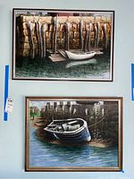 Two framed nautical acrylic paintings hanging on wall, showing boats moored at docks, signed by Donald Gotz