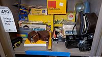 Photo showing various vintage flashbulb boxes from GE, Sylvania, M3B, Fotomat, Kodak Ready Mounts box, two leather camera cases, and Falcon Miniature camera.