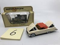 Photo of the boxed 1912 Ford Model T Captain Morgan rum Matchbox truck alongside the 1957 Corgi Ford Thunderbird model with orange hard top and open hood