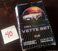 Box of 1991 Corvette Inaugural Edition trading cards showing front with car image and text describing the set contents including autographed cards and sealed packs.