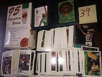 Image showing the sealed box of 95 Signature Series basketball cards along with numerous loose basketball cards spread out on a surface.