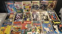 Photo showing entire set of 26 comic books arranged in sleeves on a table.