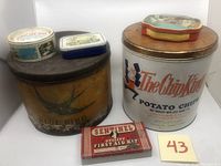 Overview of six vintage advertising tin cans grouped for sale, including Blue Bird, Chip King, Sentinel First Aid Kit, Turtle Wax, Boy Blue, and Comptoir Sud-Pacifique tins