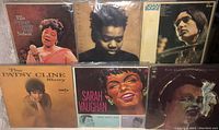 Six vintage female artist LP vinyl records arranged in two rows; top row: Ella Fitzgerald, Tracy Chapman, Joan Baez; bottom row: Patsy Cline, Sarah Vaughan, Billie Holiday. All visible album cover art and condition.