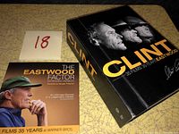 Box set closed showing front cover with three profiles of Clint Eastwood and a DVD titled The Eastwood Factor extended version documentary disc.