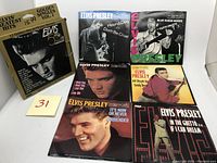 Photo of the full set including original box with six Elvis Presley 45 RPM golden vinyl singles in picture sleeves laid out for clear view.