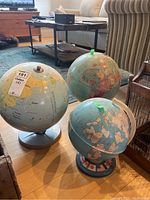 View of all three globes, showing size differences and stand conditions.