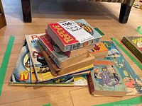 Stack of vintage Popeye storybooks and comics with colorful illustrated covers and visible wear.