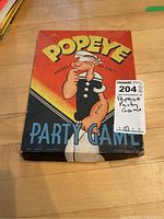 Closed vintage Popeye Party Game box with colorful artwork of Popeye in his sailor outfit, with large text on the front.
