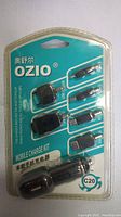 Front view of sealed Ozio C20 mobile charge kit showing charger and connectors inside blister pack