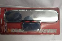 Single car room mirror model 3K5028 in sealed red factory packaging showing reflective rectangular mirror and black clamp