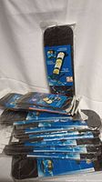 Stack of black car CD holders in factory packaging showing package labels and quantity of 24.