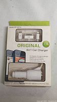 Photo of 4in1 car charger model DP-C014 in original packaging with connectors USB, SAM, and Apple showing capability for iPad/4G/4S/iP1000/Micro/ iP5/iPAD mini.