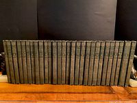 Front view of all 30 volumes of Chronicles of Canada antique book series neatly lined up, missing volumes 28 and 29 from the set as per seller