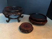 Overview of all three vintage carved rosewood stands showing varying sizes and styles.