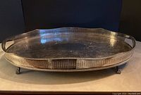 Front angled view of the oval silver plated galley tray showing reticulated edge and ball & claw feet.