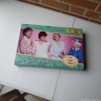 Full view of the Golden Girls Clue game box showing all main characters from the show and branding.