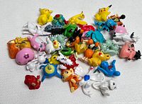 Top-down photo displaying all 35 Pokemon PVC figures arranged randomly, showing variety of characters and colors