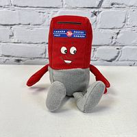 Front view of plush Canada Post mailbox toy with smiling face and logo on front