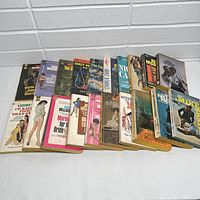 Front view showing all 20 paperback books aligned horizontally, spines and covers partially visible, showcasing vintage pulp detective and mystery art style.