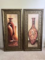 Frontal image of two framed paintings showing bronze and orange vases with golden ornate frames.