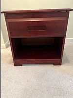 Front view of the wooden children's nightstand showing the drawer and open bottom shelf in rich chocolate finish.