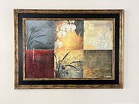 Rectangular framed picture showing six square blocks in different colors with floral and botanical designs in a brown, gold, red, cream, and gray palette, with wooden brown and gold frame and black matte inner border.