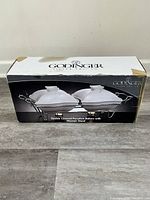 Box front showing image of Godinger double porcelain covered bakers on metal warmer stand.