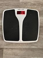 Top view of Health o Meter digital bathroom scale showing textured black footpads and red digital display on white base.