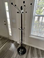 Full photo of coat rack showing height, marble base, walnut finish, and chrome hooks with black plastic ends.