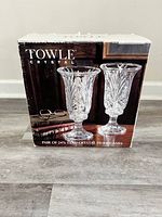 Box packaging showing the Towle Crystal brand and image of paired 24% lead crystal hurricanes.