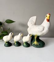 Photo showing the hen and three chicks side by side, displaying size and design