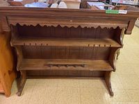 Buffet and hutch showing front wooden surfaces with shelves and plate rack slots.