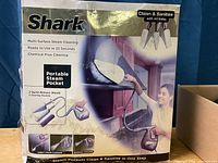 Photo of the Shark multi-surface steam cleaner box showing branding, features, and images of the device in use