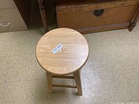 Top view of the round wooden stool showing natural wood grain and smooth polished surface.
